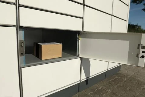 Open box with package in parcel locker Stock Photos