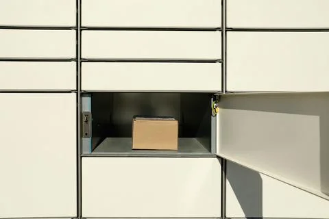 Open box with package in parcel locker 스톡 사진