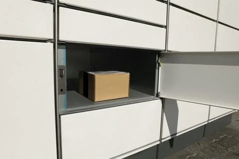 Open box with package in parcel locker 스톡 사진