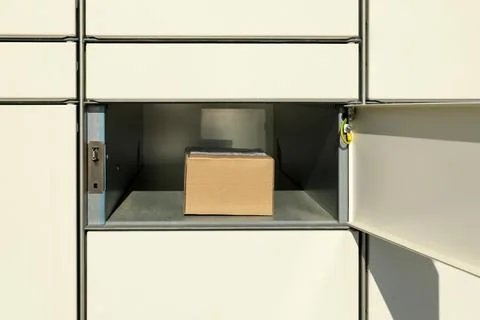 Open box with package in parcel locker 스톡 사진