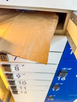 Open box with package in parcel locker Stock Photos