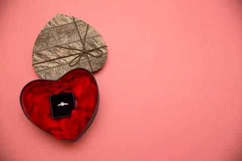 Open box with a ring on a pink background Stock Photos