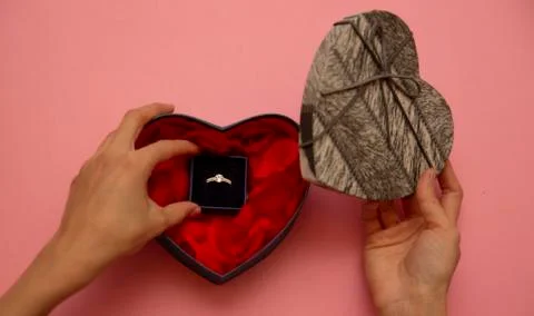 Open box with a ring on a pink background Stock Photos