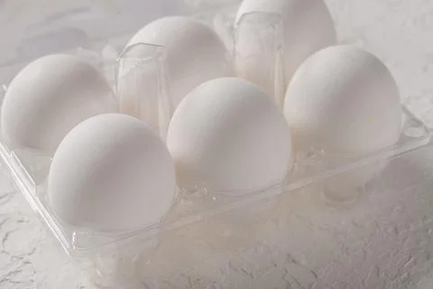 Open box with six whole white eggs  on white background with clipping path. F Stock Photos