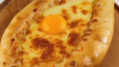 Open bread pie with cheese and egg yolk, Georgian cuisine, Adjarian khachapuri Stock Footage 83160349