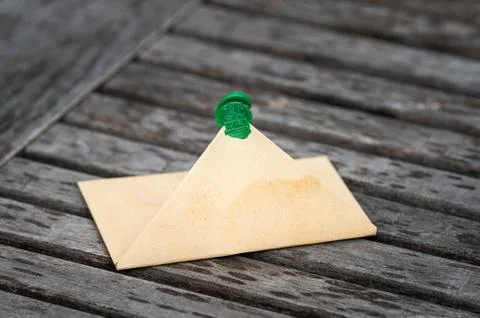 Open brown paper envelope lying on a table Stock Photos