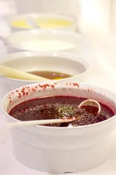 Open buffet at the hotel. Raspberry jam on white bowl with spoon Stock Photos