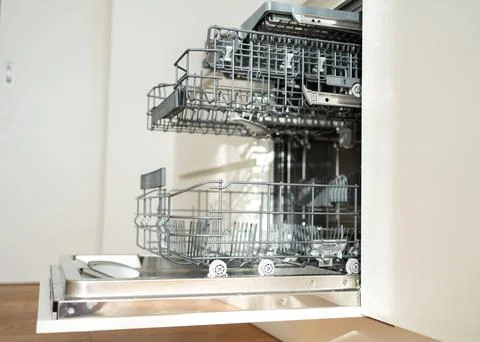 Open built-in empty dishwasher with shelves extended 写真素材