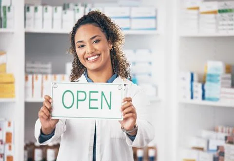 Open, business sign and woman portrait in a pharmacy with billboard from medical Stock Photos