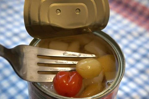 Open canned fruit salad with fork close-up Fotos Stock