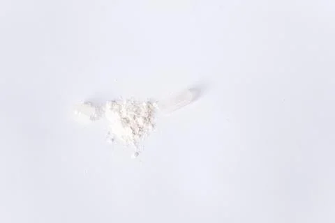 Open capsule with lactobacilli or probiotics on a white background. There is Stock Photos