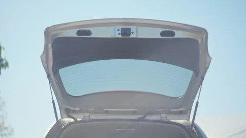 Open Car Trunk Under a Beautiful Clear Blue Sky in the Background Stunning 4K Stock Footage 309019761