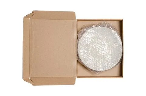 An open cardboard box with bubble wrap. The concept of packaging parcels with Stock Photos
