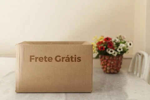 Open cardboard box with flowers on the side. Delivery box being opened writte Stock-Fotos
