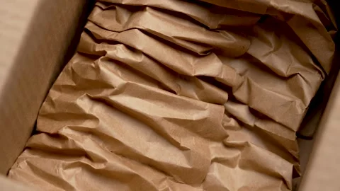 Open cardboard box with soft paper padding Stock Footage 318457245