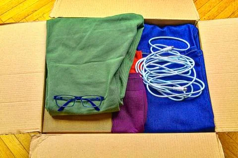 Open cardboard box with things for moving into new house or tidying away. Stock-Fotos