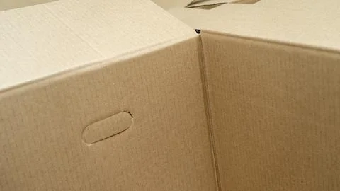 Open cardboard boxes close-up, cutout for handle in cardboard box Stock Photos