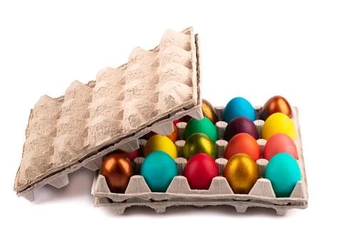 Open cardboard package with colorful Easter eggs on a white background. Stock Photos