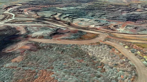 Open-cast iron ore mining operation with irreparable land degradation Stock Footage 332940420