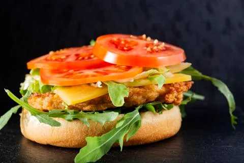 Open cheeseburger with arugula Stock Photos