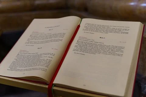 Open Christian text displaying prayers in a Poznan church during a service Stock Photos