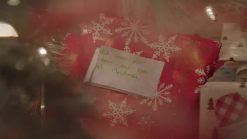 Open at Christmas Note on a Gift Beneath the Tree Stock Footage 270309104