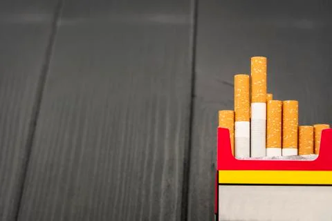 Open cigarette pack on gray background Stock Photos