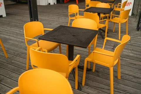 Open city cafe with empty dining room table and chairs outside Stock Photos