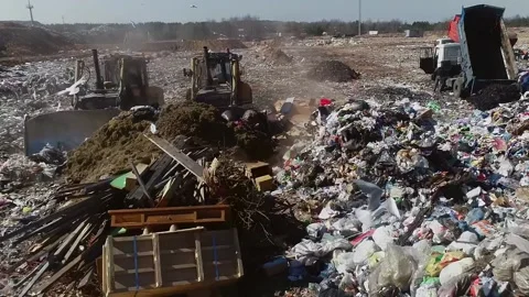 Open city garbage dump. Birds are flying, a bulldozer is leveling piles, WASTEP5 Stock Footage 150018455