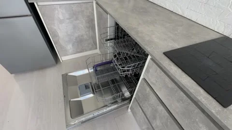 Open clean empty dishwasher in kitchen. Home appliance Stock Footage 279268476