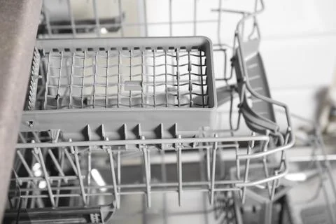 Open clean empty dishwasher in kitchen, closeup Stock Photos