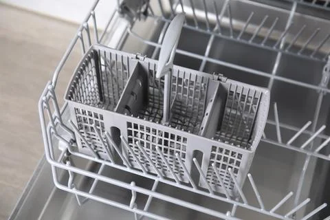 Open clean empty dishwasher in kitchen, closeup Stockfoto's
