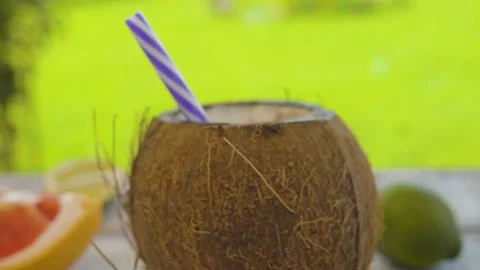 Open coconut with drinking straw Stock Footage 137084877