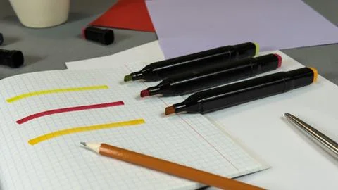 Open Colored Felt Tip Pens lie on the open notebook. Stock Photos