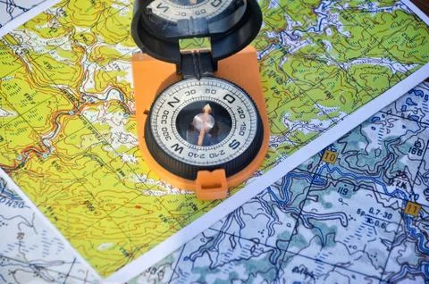 Open compass on the map Stock Photos