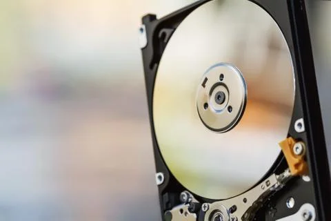 Open computer hard disk drive (HDD) with spindle and plate. Stock Photos
