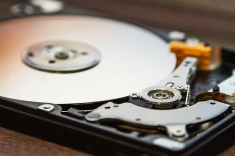 Open computer hard disk drive (HDD) with spindle and plate. Stock Photos