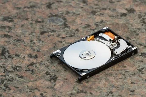 Open computer hard disk drive (HDD) with spindle and plate. Stock Photos