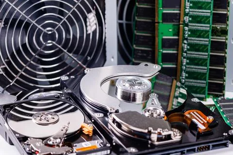 An open computer hard drive between other parts of the computer, concept of d Stock Photos