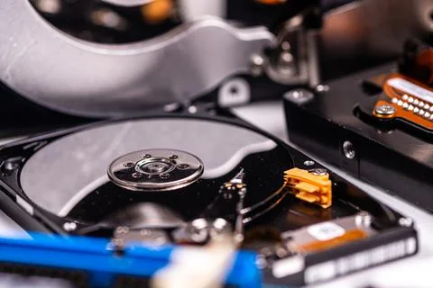 An open computer hard drive between other parts of the computer, concept of d Stock Photos