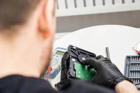 Open Computer Hard Drive in Hands in black gloves. Stock Photos