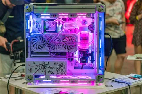 Open computer tower with pink internal glow, visible hardware fans, cables, a Stock Photos