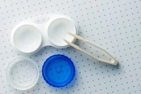 Open container for lenses and plastic tweezers. View from above. Stock Photos