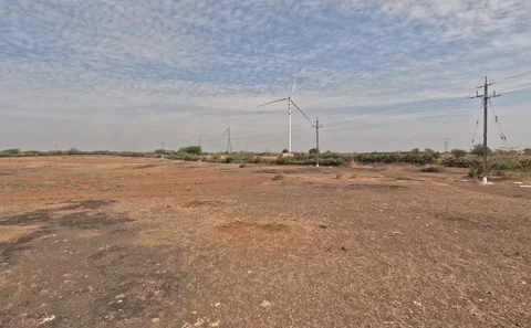 Open Countryside Landscape under Textured Cloud Sky with Rotating Renewable Stock Footage 342859966