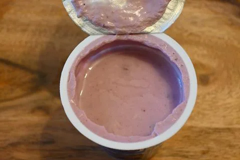 Open cup of fruit yogurt Fotos Stock