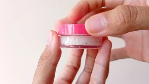 Open up a cute small pink jar with white background Stock Footage 145463418