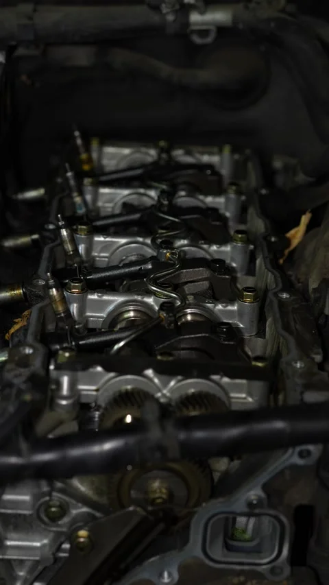 An open cylinder head of a diesel car engine reveals complex internal compone Stock Footage 345108917