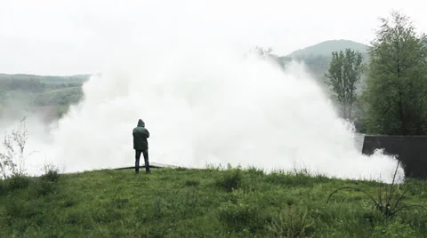 Open dam discharged a large amount of water from lake reservoir, man standing. Stock Footage 37788153