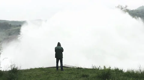 Open dam discharged a large amount of water from lake reservoir, man standing. Stock Footage 37799268