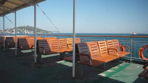 Open deck of the ferry on a sunny day with no people empty wooden chairs Stock Footage 281264700